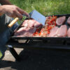 Dando vuelta carne en la plancha bifera premium sobre la parrilla